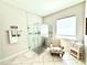 Bathroom with a glass walk-in shower, tiled walls, and decorative chair and table at 31889 Tortuga Shore Loop, Wesley Chapel, FL 33545