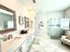 Bright bathroom with dual sinks, glass shower, and modern fixtures in a luxurious design at 31889 Tortuga Shore Loop, Wesley Chapel, FL 33545