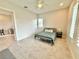 Bright bedroom featuring a ceiling fan, tile flooring, and an open door to an adjacent room at 31889 Tortuga Shore Loop, Wesley Chapel, FL 33545