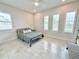 Bright bedroom with tile flooring, plantation shutters and accent pillows at 31889 Tortuga Shore Loop, Wesley Chapel, FL 33545