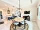 Open concept dining area with round table and decorative rug, flowing into the kitchen and living spaces at 31889 Tortuga Shore Loop, Wesley Chapel, FL 33545