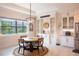 Charming dining area with a modern chandelier and views of the backyard and swimming pool at 31889 Tortuga Shore Loop, Wesley Chapel, FL 33545