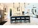 This spacious kitchen features an island with seating, pendant lighting, and modern stainless steel appliances at 31889 Tortuga Shore Loop, Wesley Chapel, FL 33545