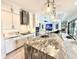 Stylish kitchen with white cabinets, stainless steel appliances, and a large island with stone countertop at 31889 Tortuga Shore Loop, Wesley Chapel, FL 33545