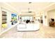 Spacious living room featuring recessed lighting, tile floors, tray ceiling, and a large TV and entertainment center at 31889 Tortuga Shore Loop, Wesley Chapel, FL 33545