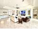 Inviting living room with tile floors, a built-in bar, cozy seating, and an entertainment center for relaxing evenings at 31889 Tortuga Shore Loop, Wesley Chapel, FL 33545