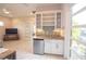 Living space featuring a kitchenette with granite countertops, a stainless steel mini-fridge, and an open design at 31889 Tortuga Shore Loop, Wesley Chapel, FL 33545