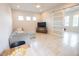 Bright living space with a kitchenette, television, comfortable seating and sliding door that leads to another space at 31889 Tortuga Shore Loop, Wesley Chapel, FL 33545