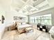 Spacious main bedroom with a coffered ceiling, accent rug, and large windows at 31889 Tortuga Shore Loop, Wesley Chapel, FL 33545