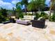 Outdoor patio with plush seating, modern fire pit, and professionally landscaped yard at 31889 Tortuga Shore Loop, Wesley Chapel, FL 33545