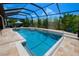Relaxing backyard pool area, surrounded by lush landscaping and a screened enclosure for year-round enjoyment at 31889 Tortuga Shore Loop, Wesley Chapel, FL 33545