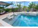 Inviting pool with sun loungers and a waterfall feature, perfect for relaxing in the Florida sunshine at 31889 Tortuga Shore Loop, Wesley Chapel, FL 33545
