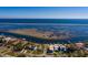 Expansive waterfront home aerial view featuring a private boat dock, lush landscaping, and a sunny locale at 3319 Bayshore Ne Blvd, St Petersburg, FL 33703