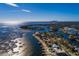 Scenic aerial view of waterfront property, in-ground pool, and private dock on a sunny day at 3319 Bayshore Ne Blvd, St Petersburg, FL 33703