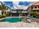 Inviting backyard pool and spa with travertine tile with a modern home in the background at 3319 Bayshore Ne Blvd, St Petersburg, FL 33703