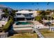 Aerial view of a backyard featuring a pool, spa, and dock with a seawall at 3319 Bayshore Ne Blvd, St Petersburg, FL 33703