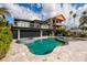 Modern home with outdoor kitchen and pool and spa with beautiful travertine pavers at 3319 Bayshore Ne Blvd, St Petersburg, FL 33703