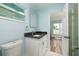 Bright bathroom featuring a white vanity with granite countertop, toilet, and view to adjacent room at 3319 Bayshore Ne Blvd, St Petersburg, FL 33703