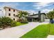 Paved driveway of a home showcasing an attached garage, well maintained lawn, and plants at 3319 Bayshore Ne Blvd, St Petersburg, FL 33703