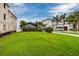 Lush front lawn of a residential property with palm trees and a driveway at 3319 Bayshore Ne Blvd, St Petersburg, FL 33703