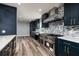 A kitchen featuring blue cabinets, stainless steel appliances, and bright countertops, offering a modern aesthetic at 3319 Bayshore Ne Blvd, St Petersburg, FL 33703