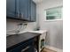 A laundry room with modern cabinets, a sleek countertop, and a functional sink setup at 3319 Bayshore Ne Blvd, St Petersburg, FL 33703