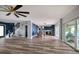 An open-concept living space with dining area, hardwood floors, stylish decor, and access to outdoor space at 3319 Bayshore Ne Blvd, St Petersburg, FL 33703