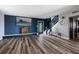 Open living room with hardwood floors, accent wall, fireplace, and staircase to the second floor at 3319 Bayshore Ne Blvd, St Petersburg, FL 33703