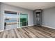 Bright living room featuring luxury vinyl flooring and glass sliding doors leading to a beautiful outdoor view at 3319 Bayshore Ne Blvd, St Petersburg, FL 33703