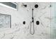A marble tiled walk-in shower with black hardware at 3319 Bayshore Ne Blvd, St Petersburg, FL 33703