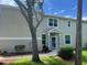 Inviting home entrance with well maintained lawn and garden at 3665 Country Pointe Pl, Palm Harbor, FL 34684