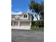 Charming two-story townhome with attached two-car garage and American flag at 3665 Country Pointe Pl, Palm Harbor, FL 34684
