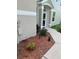 Home's entry way with a stone walkway and mulch bed at 3665 Country Pointe Pl, Palm Harbor, FL 34684