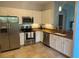 Modern kitchen with stainless steel appliances, granite countertops, and ample cabinet space at 3665 Country Pointe Pl, Palm Harbor, FL 34684