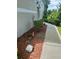 Side view of home with lush landscaping and rock border at 3665 Country Pointe Pl, Palm Harbor, FL 34684