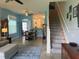 Open-concept living room showcasing backyard views and staircase at 3665 Country Pointe Pl, Palm Harbor, FL 34684