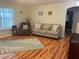 Comfortable living room with hardwood floors, couch, and an armchair at 3665 Country Pointe Pl, Palm Harbor, FL 34684