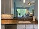 The kitchen has granite countertops and stainless steel appliances, and overlooks the living room at 3665 Country Pointe Pl, Palm Harbor, FL 34684