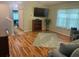 Living room featuring hardwood floors and a flat screen tv at 3665 Country Pointe Pl, Palm Harbor, FL 34684