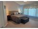 Spacious main bedroom with a king bed and comfortable bench seat at 3665 Country Pointe Pl, Palm Harbor, FL 34684