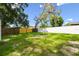 Lawn backyard with a white fence and landscaping at 4220 E Regnas Ave, Tampa, FL 33617