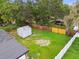 Large backyard with a shed, mature trees, and fencing for privacy at 4220 E Regnas Ave, Tampa, FL 33617