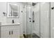 Updated bathroom features a glass shower and a modern vanity at 4220 E Regnas Ave, Tampa, FL 33617