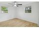 Bedroom features natural light through windows, a ceiling fan, and light wood-look floors at 4220 E Regnas Ave, Tampa, FL 33617