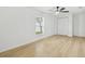 Bright bedroom with hardwood floors, ceiling fan, and natural light at 4220 E Regnas Ave, Tampa, FL 33617