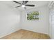 Light-filled bedroom featuring ceiling fan, closet, and window providing natural light at 4220 E Regnas Ave, Tampa, FL 33617