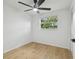 Light-filled bedroom with hardwood flooring, ceiling fan, closet, and window with outdoor views at 4220 E Regnas Ave, Tampa, FL 33617