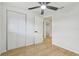 Bedroom with hardwood floors, closet, ceiling fan and views into the house at 4220 E Regnas Ave, Tampa, FL 33617