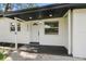 Welcoming front entry with decorative door, modern light fixture, and manicured landscaping at 4220 E Regnas Ave, Tampa, FL 33617