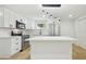 Bright kitchen with stainless appliances, island, and pendant lighting at 4220 E Regnas Ave, Tampa, FL 33617